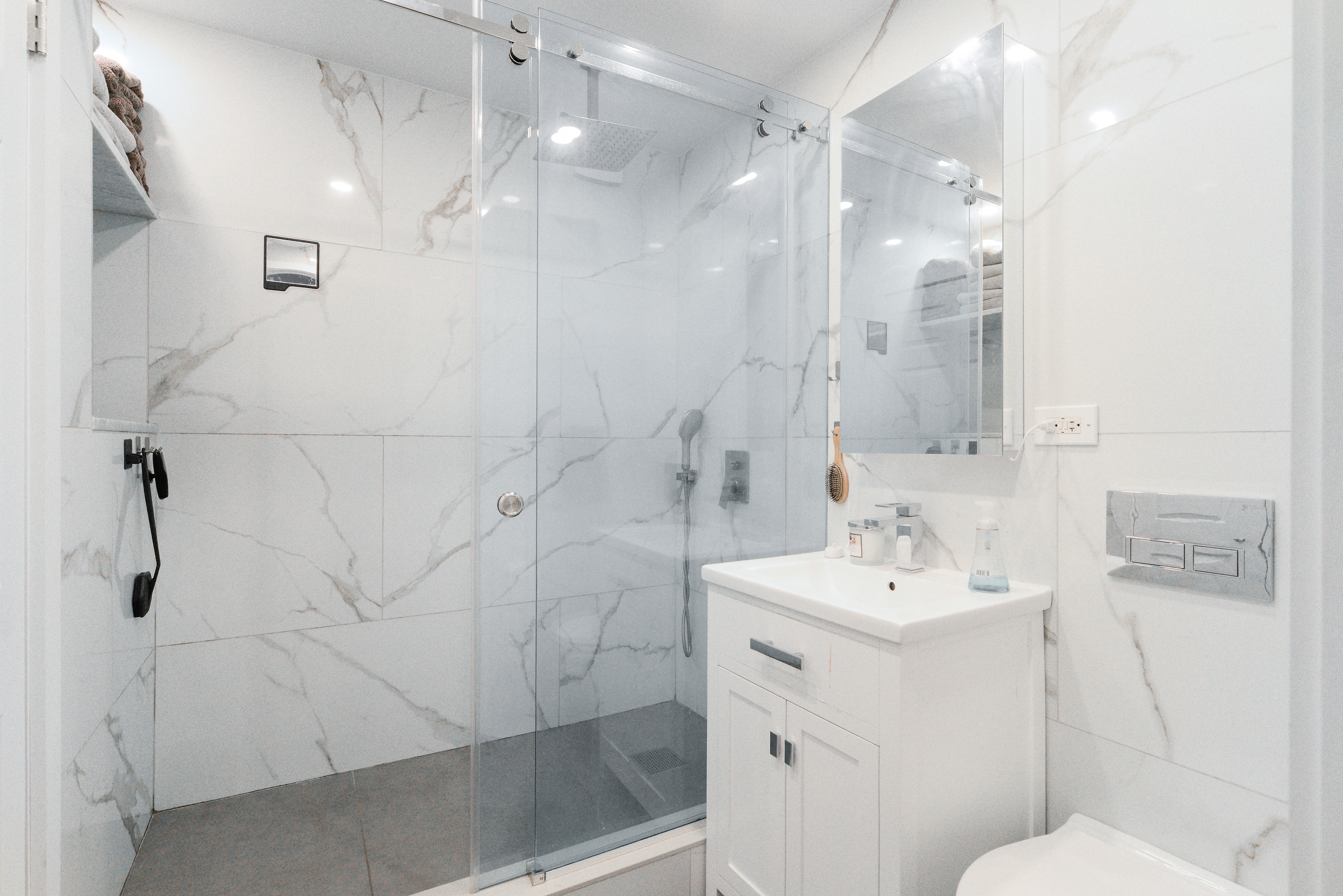 201 East 21st Street, Unit 7G Manhattan, NY 10010 - Photo 7 of 11 a bathroom with a sink a toilet and shower