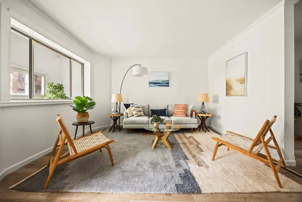 a living room with furniture a rug and a window