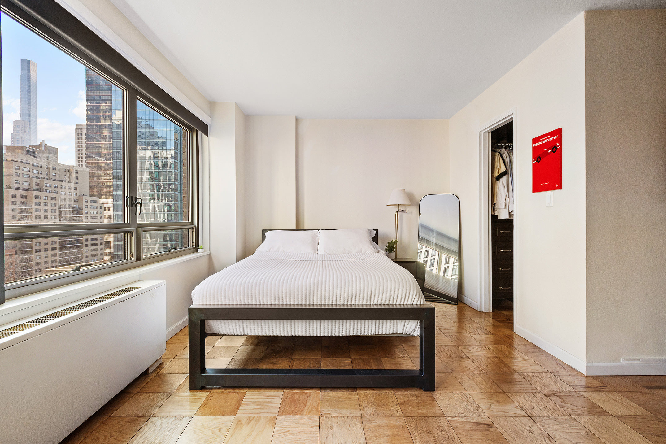 170 West End Avenue, Unit 12C Manhattan, NY 10023 - Photo 3 of 9 a bedroom with a bed and a large window