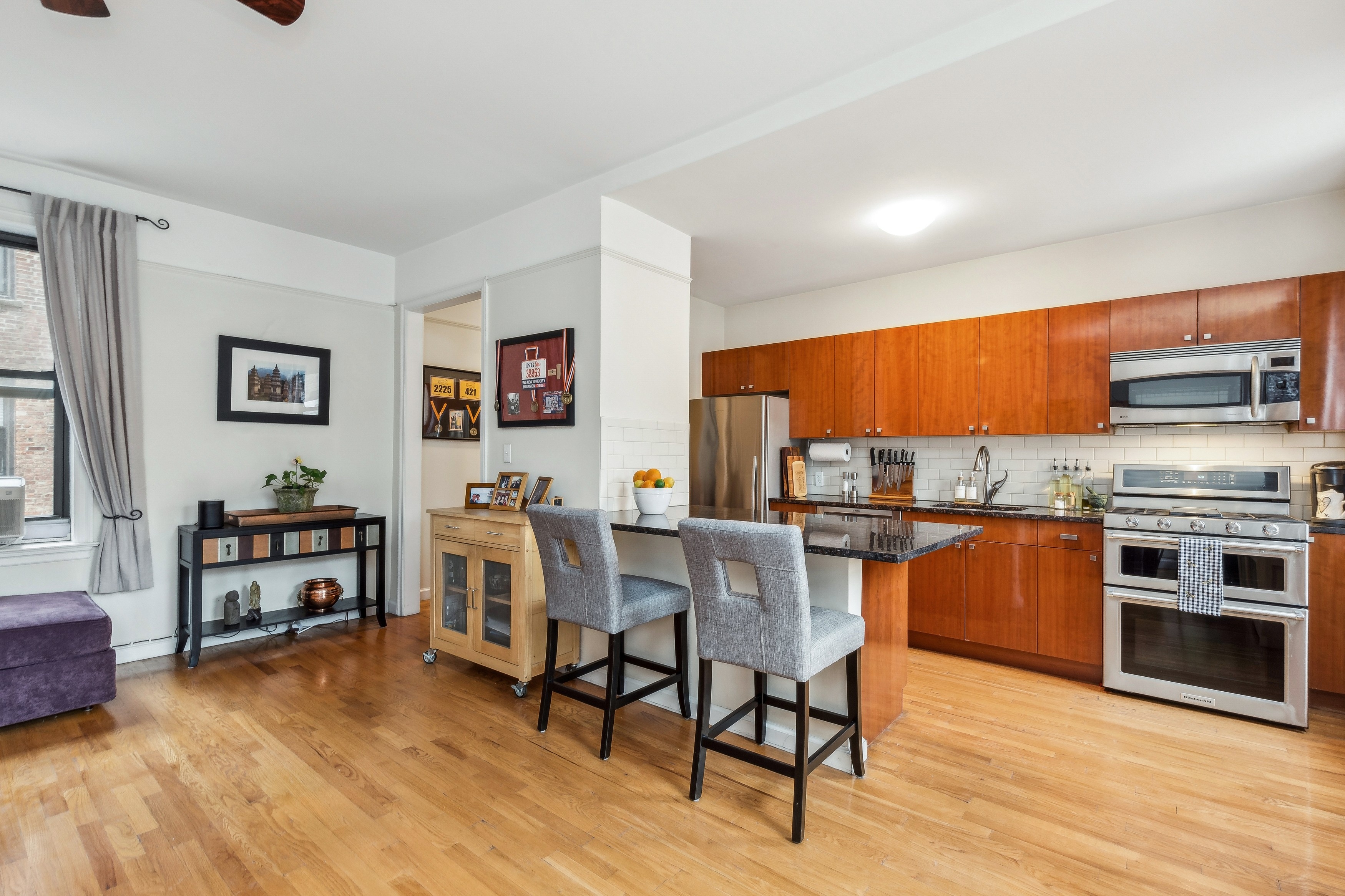 779 Riverside Drive, Unit C31 Manhattan, NY 10032 - Photo 4 of 13 a kitchen with stainless steel appliances a stove a sink cabinets and a dining table