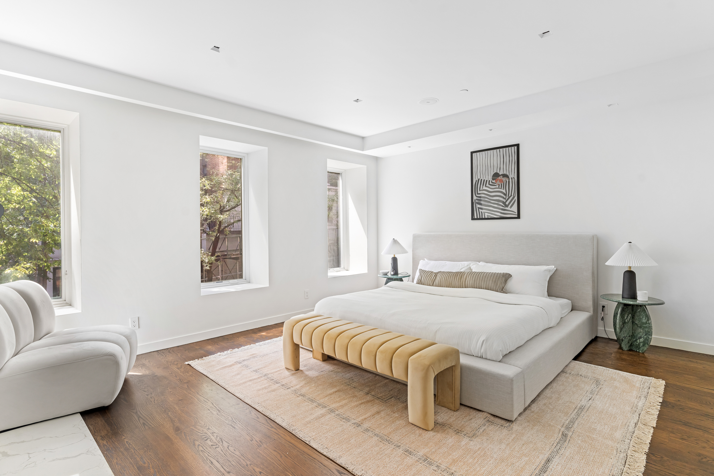 135 East 38th Street Manhattan, NY 10016 - Photo 15 of 32 a bedroom with a bed couch and a large window