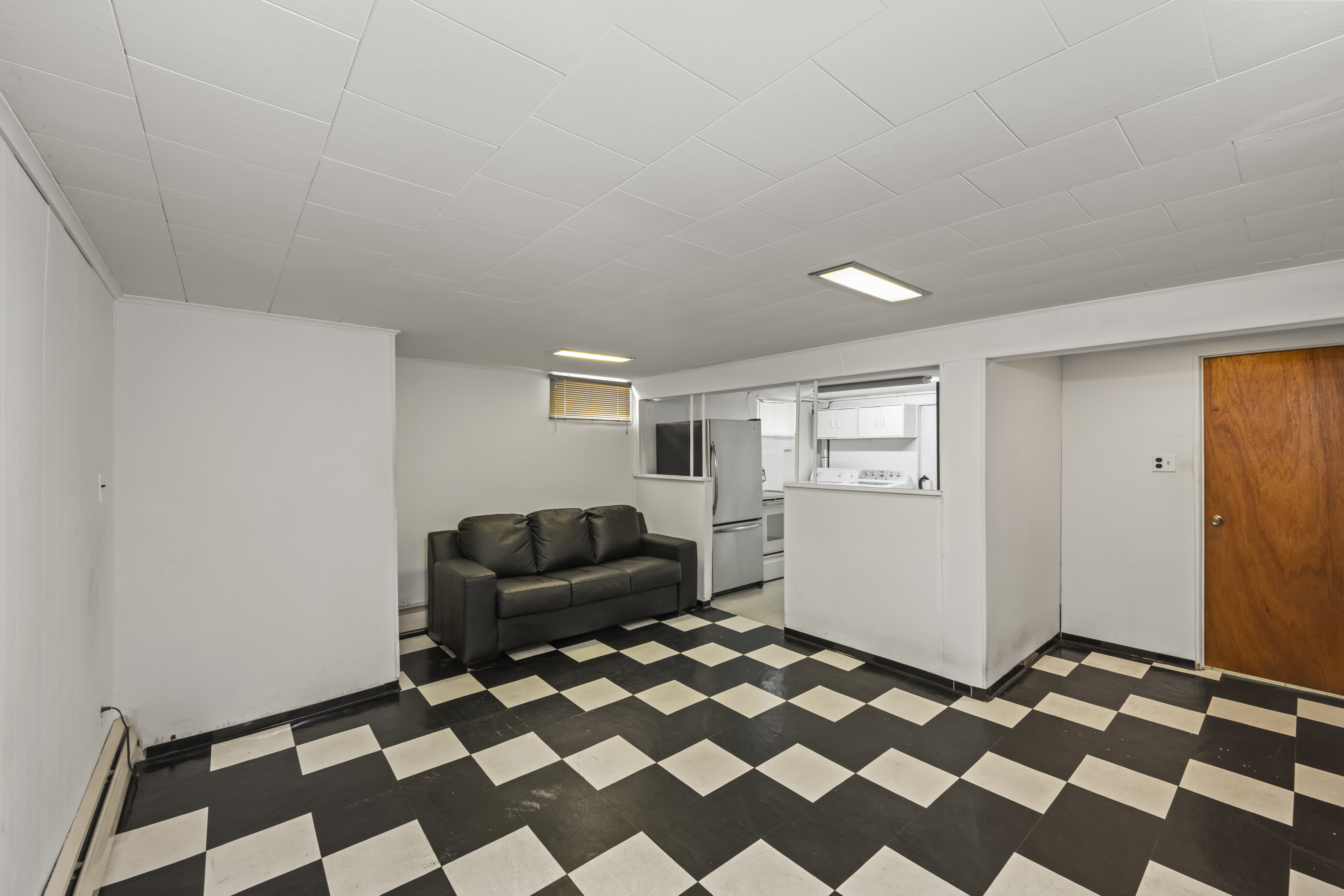 522 Stewart Avenue Staten Island, NY 10314 - Photo 20 of 33 a living room with a black white checkered floor with a black white checkered floor