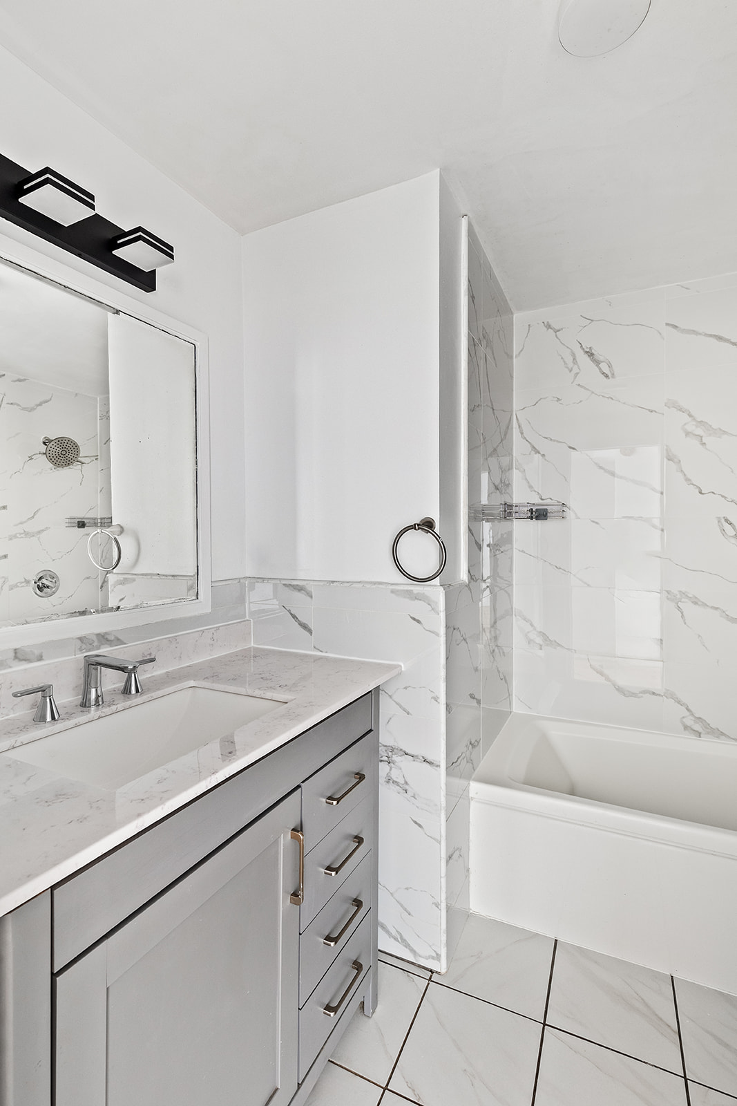 126 Waverly Place, Unit 2F Manhattan, NY 10011 - Photo 7 of 11 a bathroom with a shower sink and mirror