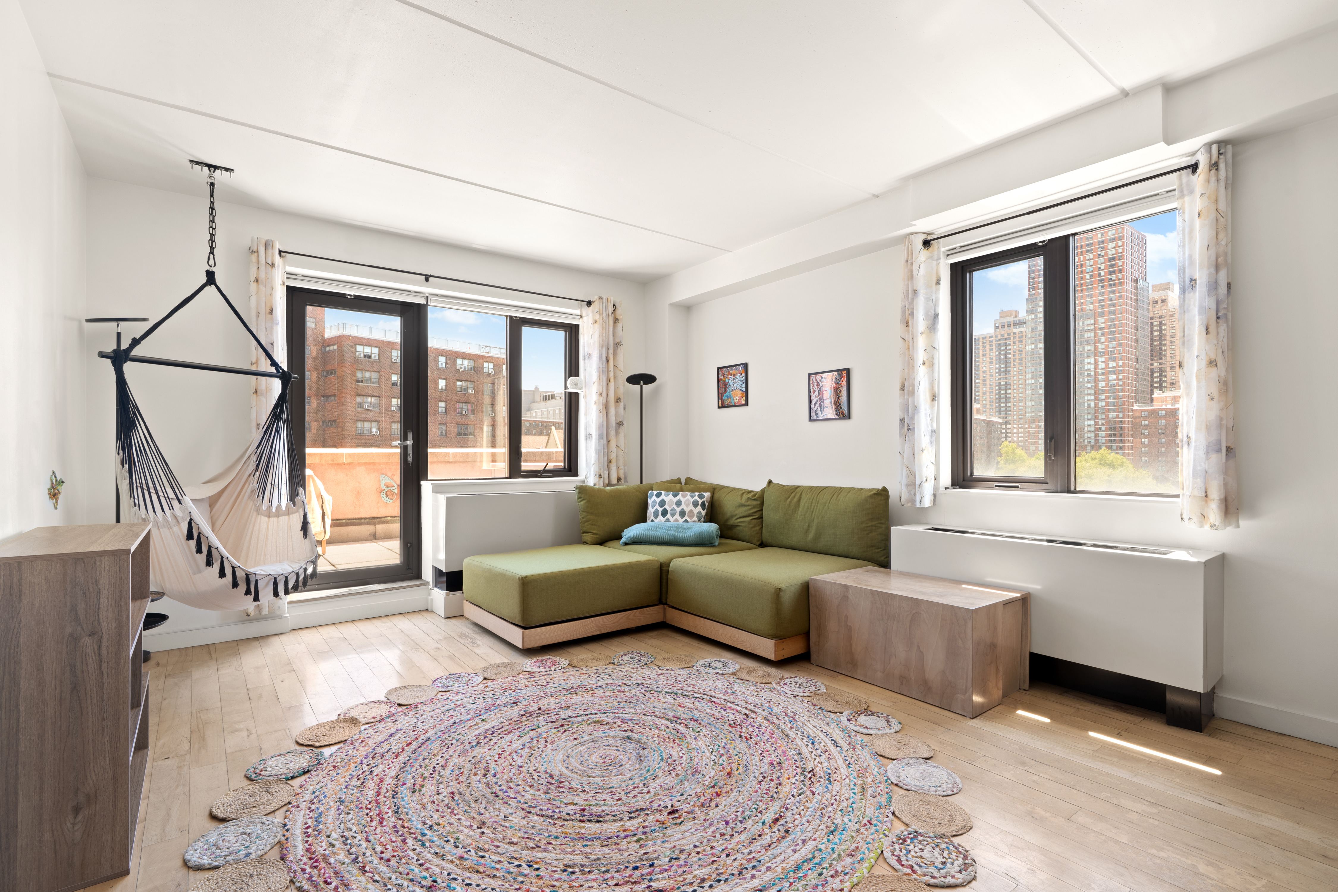 1810 3rd Avenue, Unit 9D Manhattan, NY 10029 - Photo 2 of 10 a living room with furniture and a window
