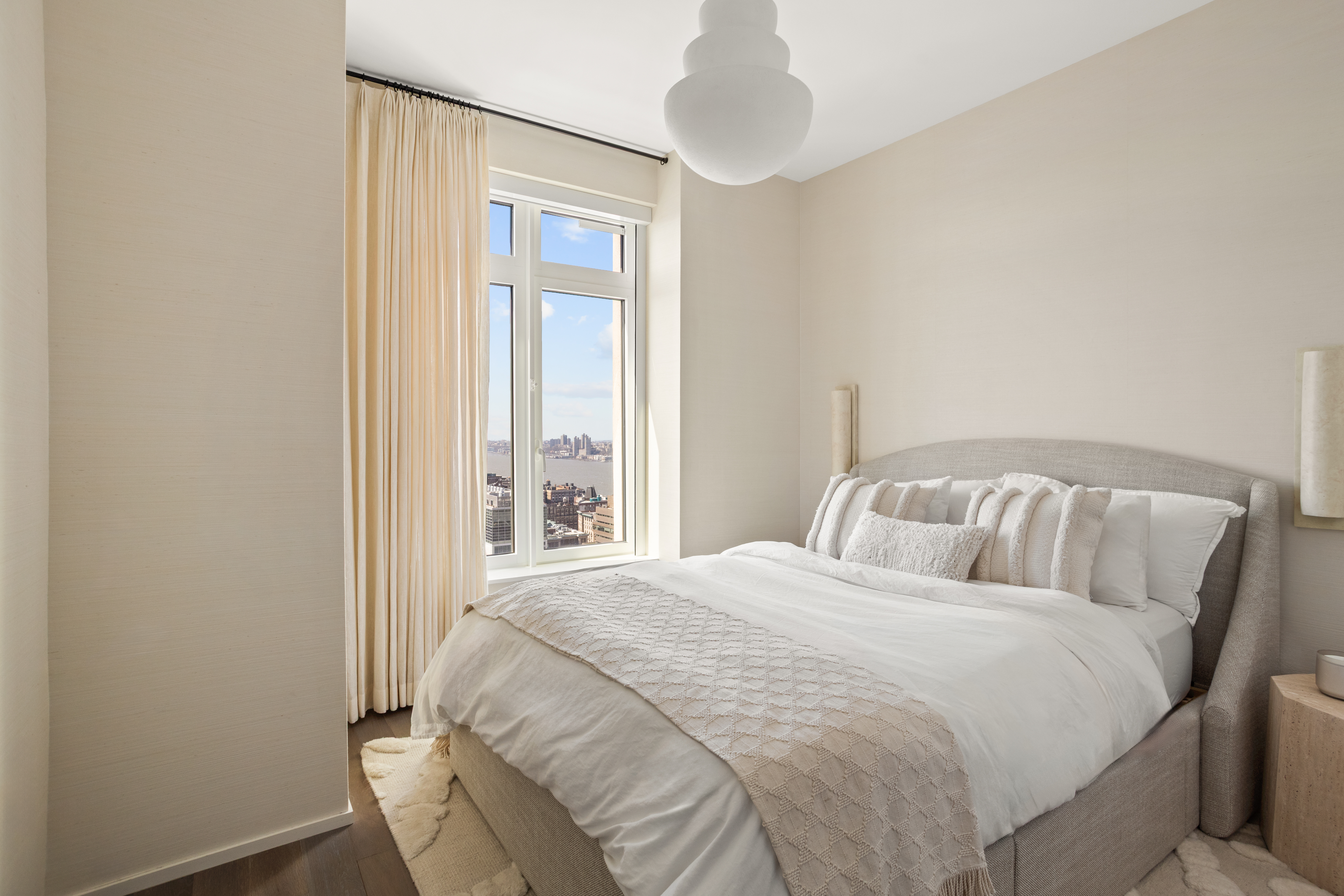 543 West 122nd Street, Unit PH31A Manhattan, NY 10027 - Photo 25 of 40 a large bed in a bedroom next to a window