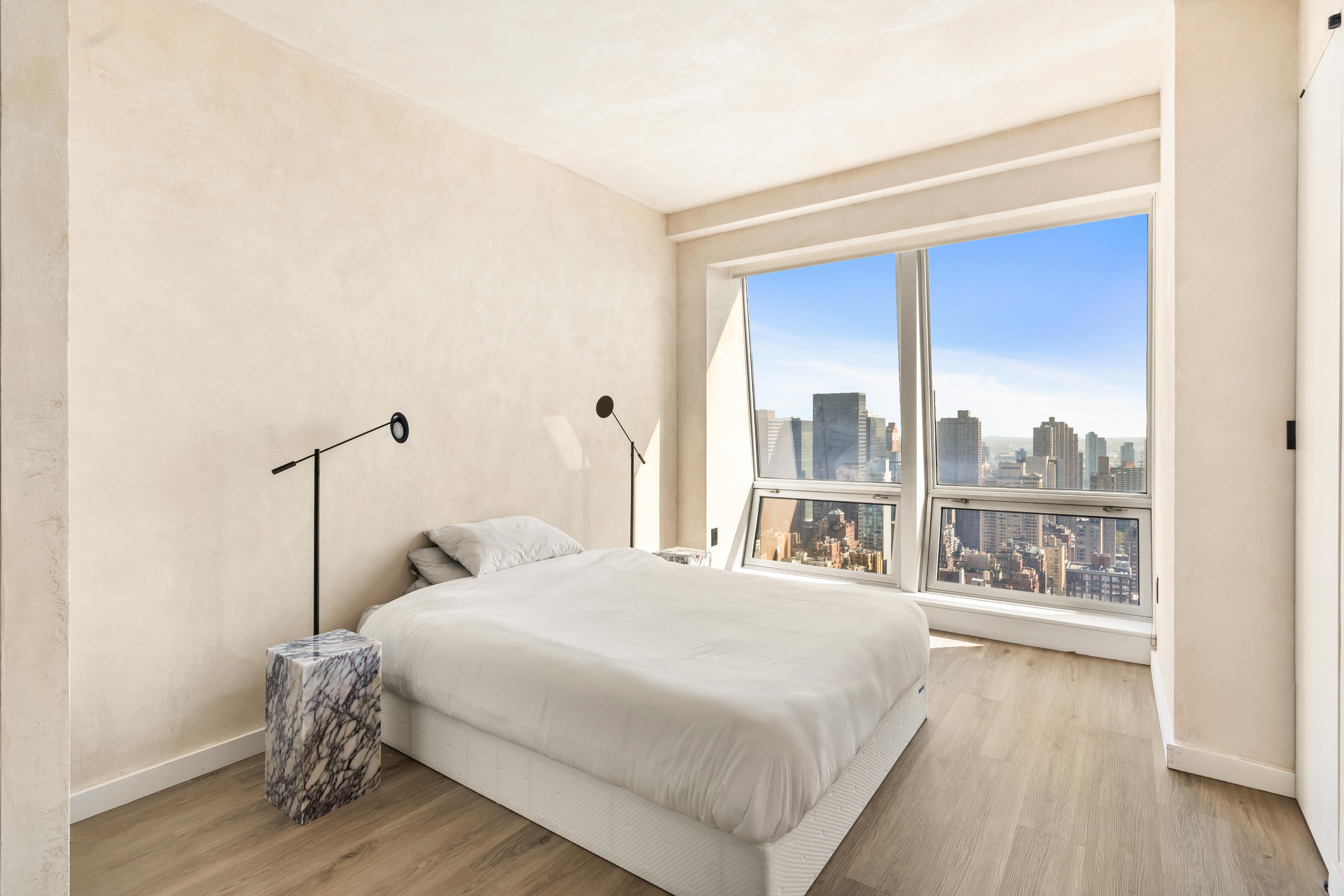 400 5th Avenue, Unit 45D Manhattan, NY 10018 - Photo 3 of 5 a bedroom with a bed and a large window