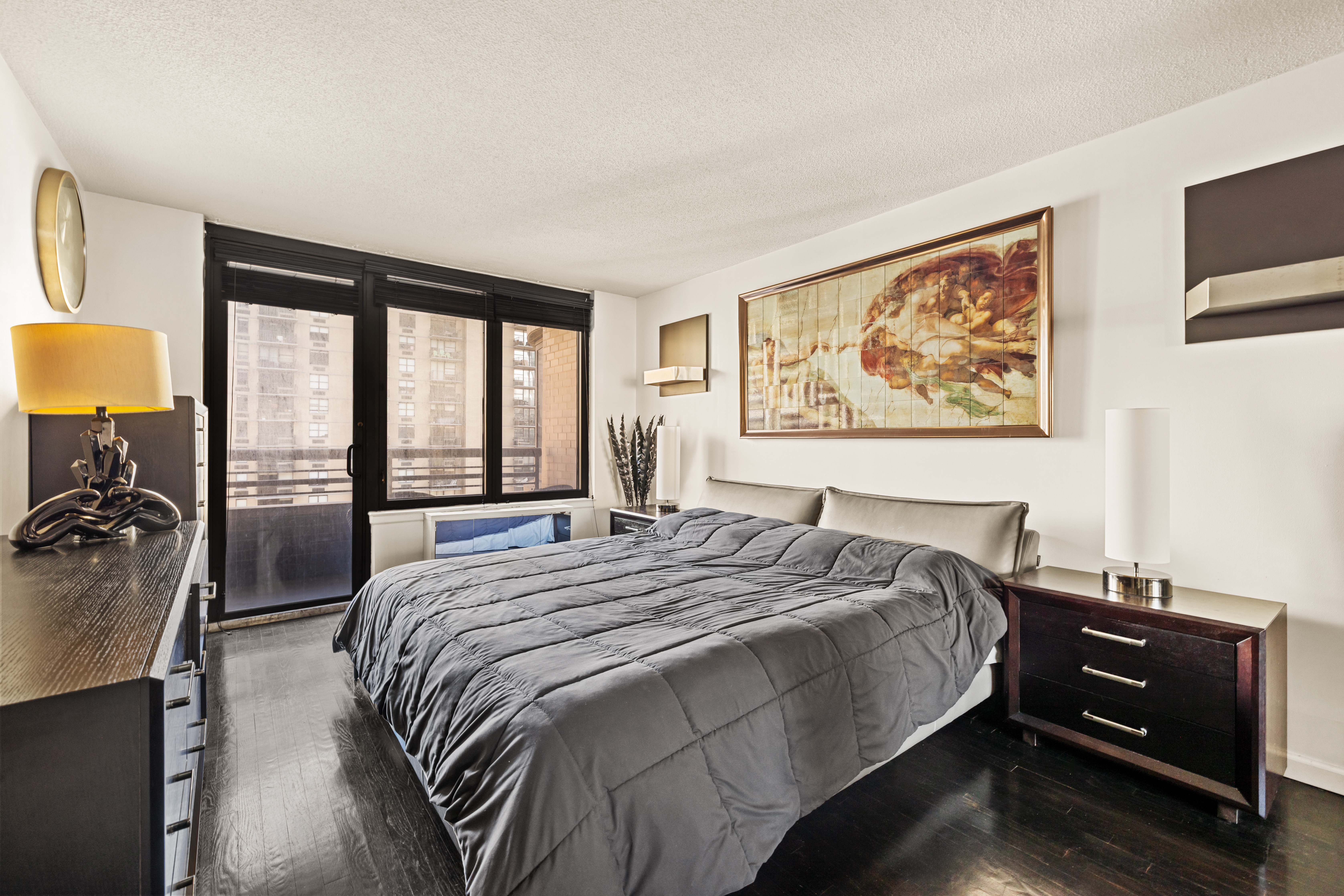 330 East 38th Street, Unit 26F Manhattan, NY 10016 - Photo 5 of 11 a bed sitting in a bedroom next to a window