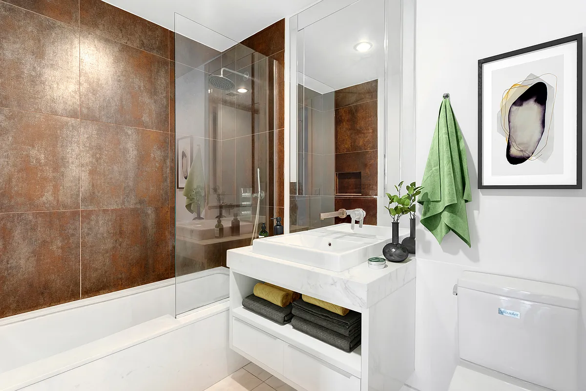 133 West 22nd Street, Unit 6A Manhattan, NY 10011 - Photo 4 of 9 a bathroom with a sink and a mirror