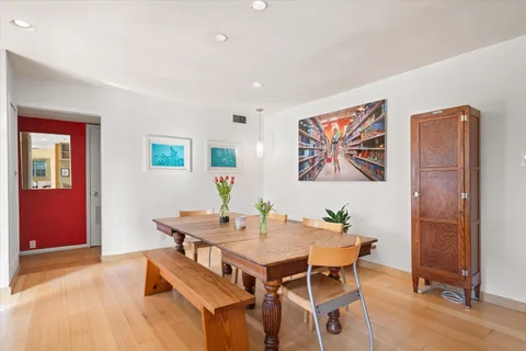 a view of a dining room with furniture window and wooden floor