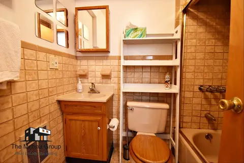 a bathroom with a toilet a sink and shower