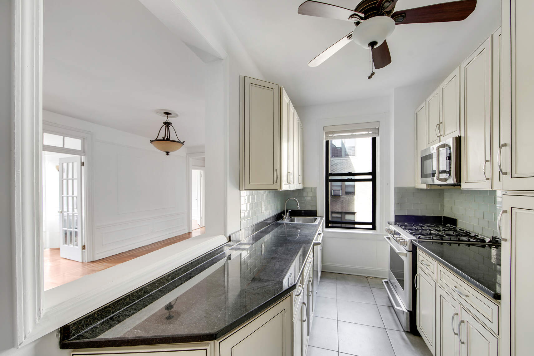 7825 4th Avenue, Unit E10 Brooklyn, NY 11209 - Photo 2 of 8 a kitchen with granite countertop a sink appliances cabinets and furniture