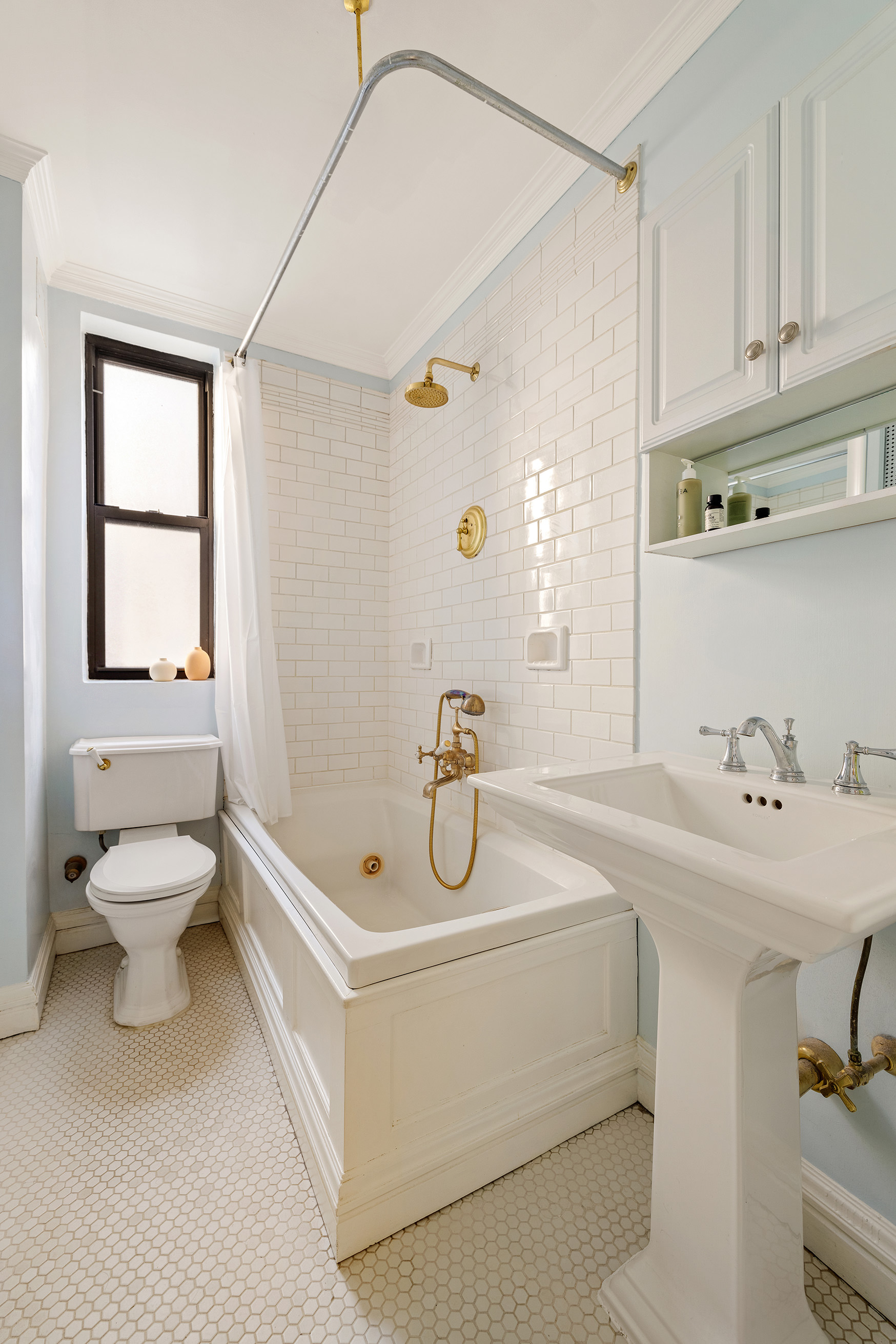 119 East 84th Street, Unit 4C Manhattan, NY 10028 - Photo 6 of 9 a bathroom with a sink a toilet and shower