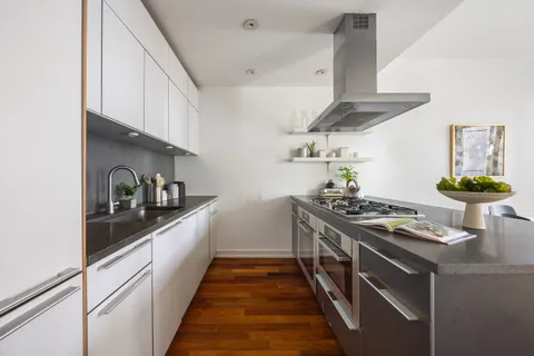 a kitchen with stainless steel appliances granite countertop a stove and a sink