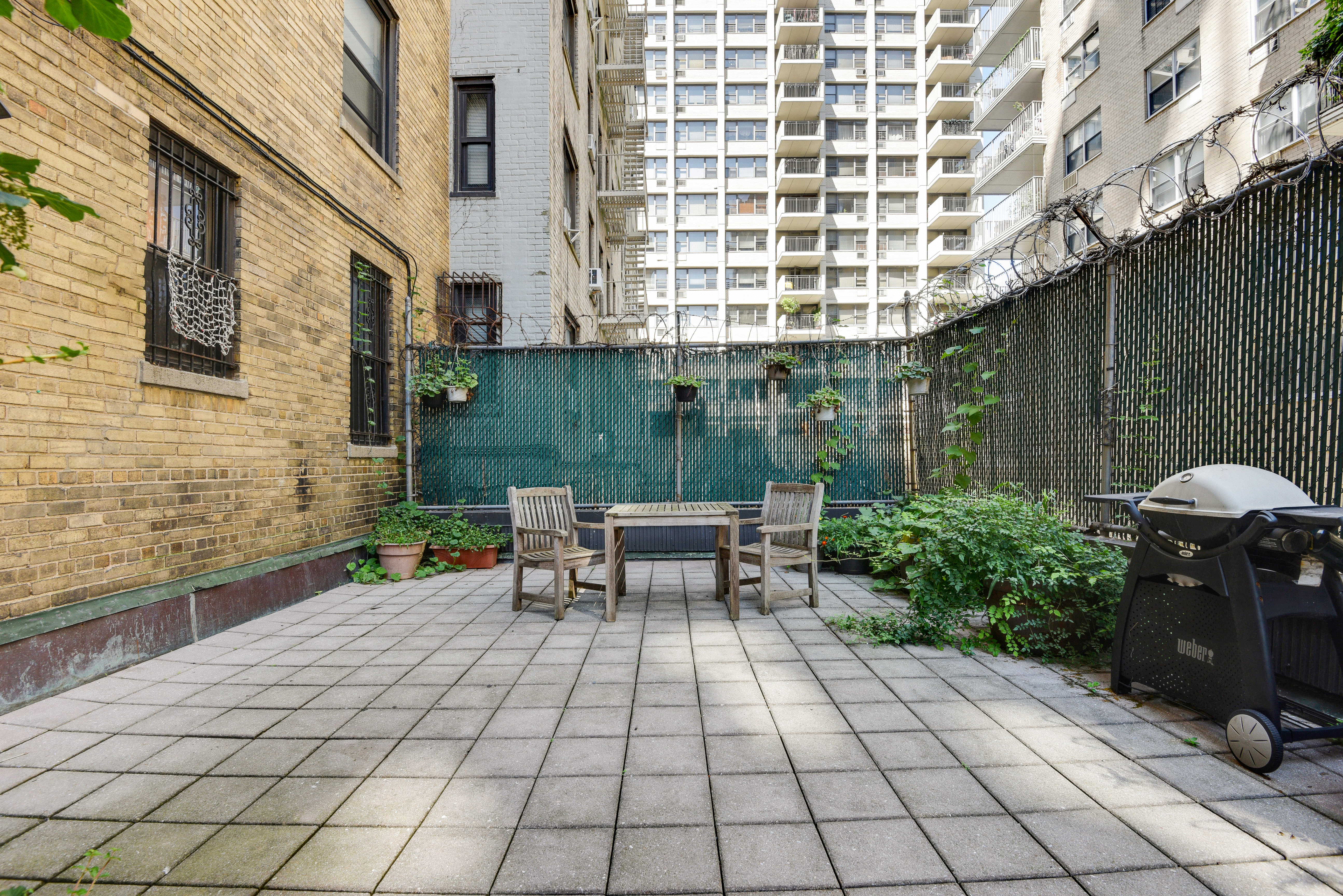 41 West 96th Street, Unit 1B Manhattan, NY 10025 - Photo 8 of 24 a view of a patio with a table and chairs