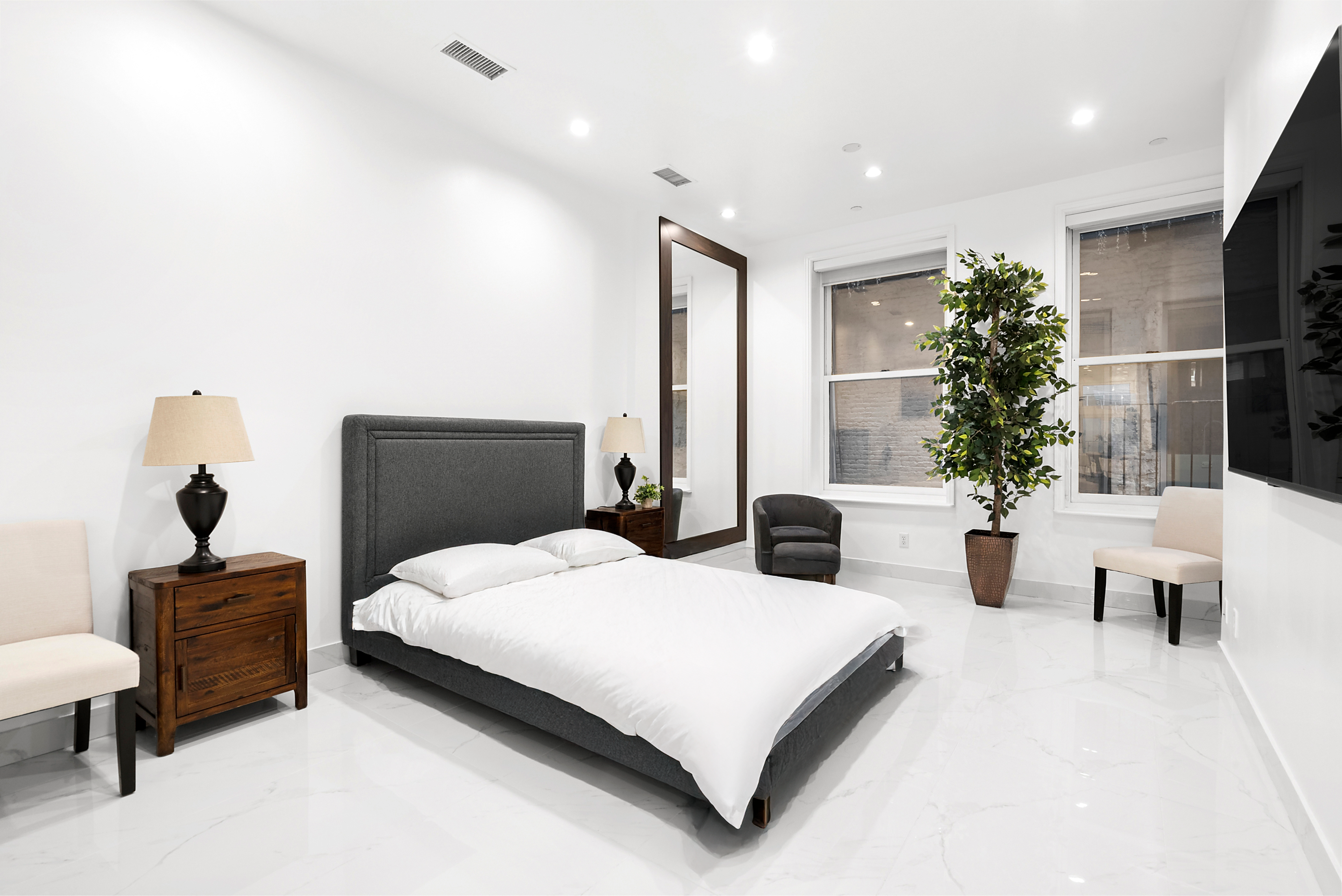 53 Murray Street, Unit 1 Manhattan, NY 10007 - Photo 9 of 12 a bedroom with a large bed and a potted plant