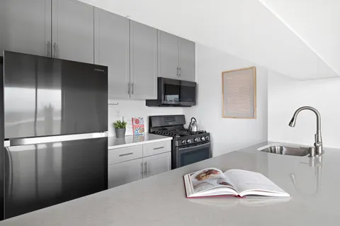 a kitchen with a refrigerator stove and a sink