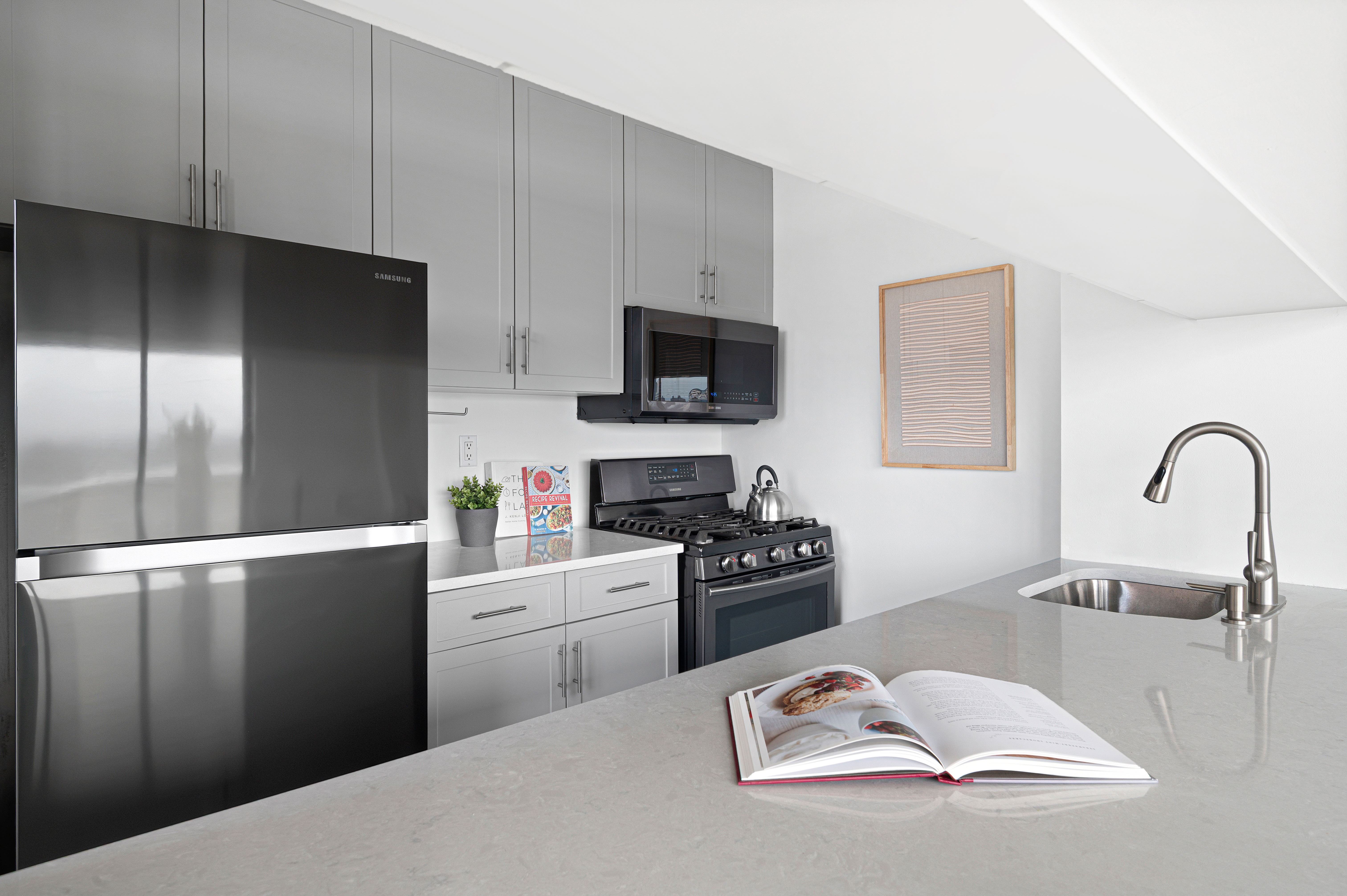350 West 50th Street, Unit PH3C Manhattan, NY 10019 - Photo 8 of 17 a kitchen with a refrigerator stove and a sink