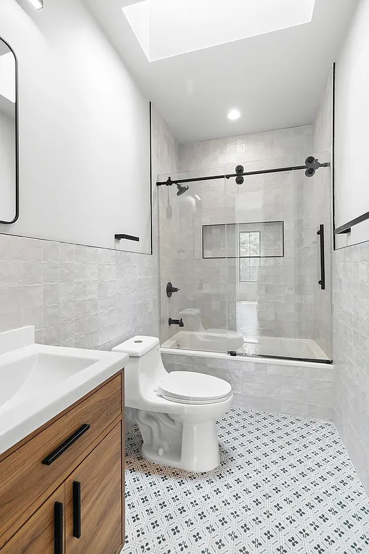 866 Bushwick Avenue, Unit 3 Brooklyn, NY 11221 - Photo 7 of 12 a bathroom with a sink a toilet and shower