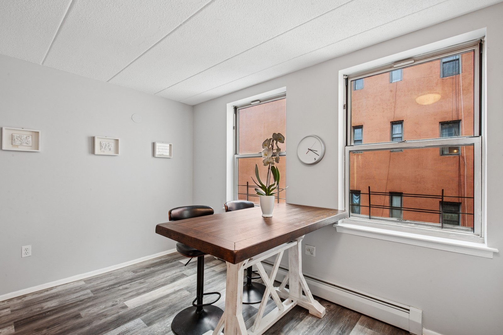 2551 Frederick Douglass Boulevard, Unit 2551D Manhattan, NY 10030 - Photo 9 of 11 a view of a workspace room with wooden floor and dining table