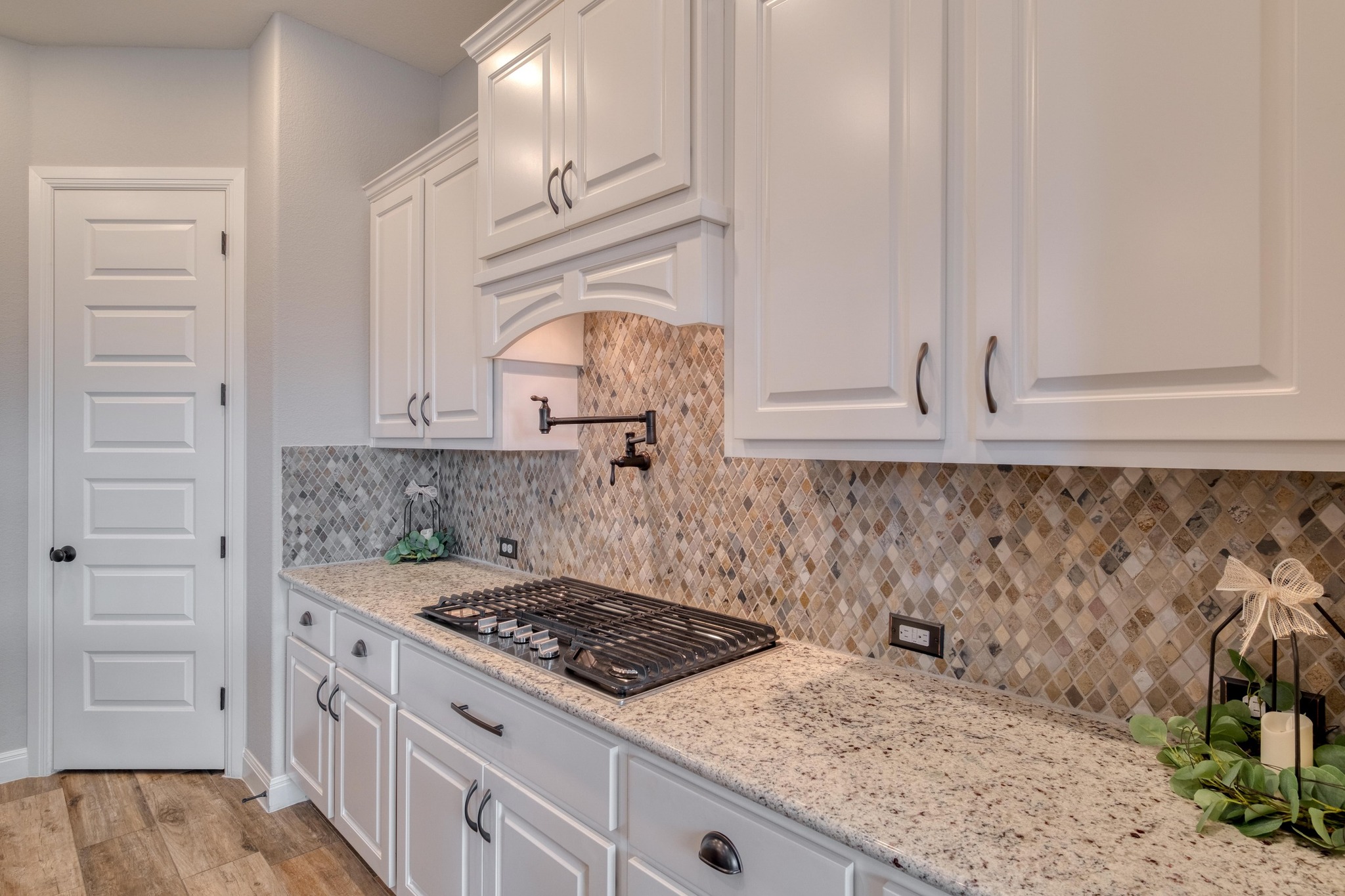 3836 Kyler Glen Road Round Rock, TX 78681 - Photo 12 of 41 a kitchen with white cabinets and sink
