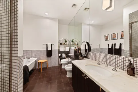 a bathroom with a sink double vanity and a tub