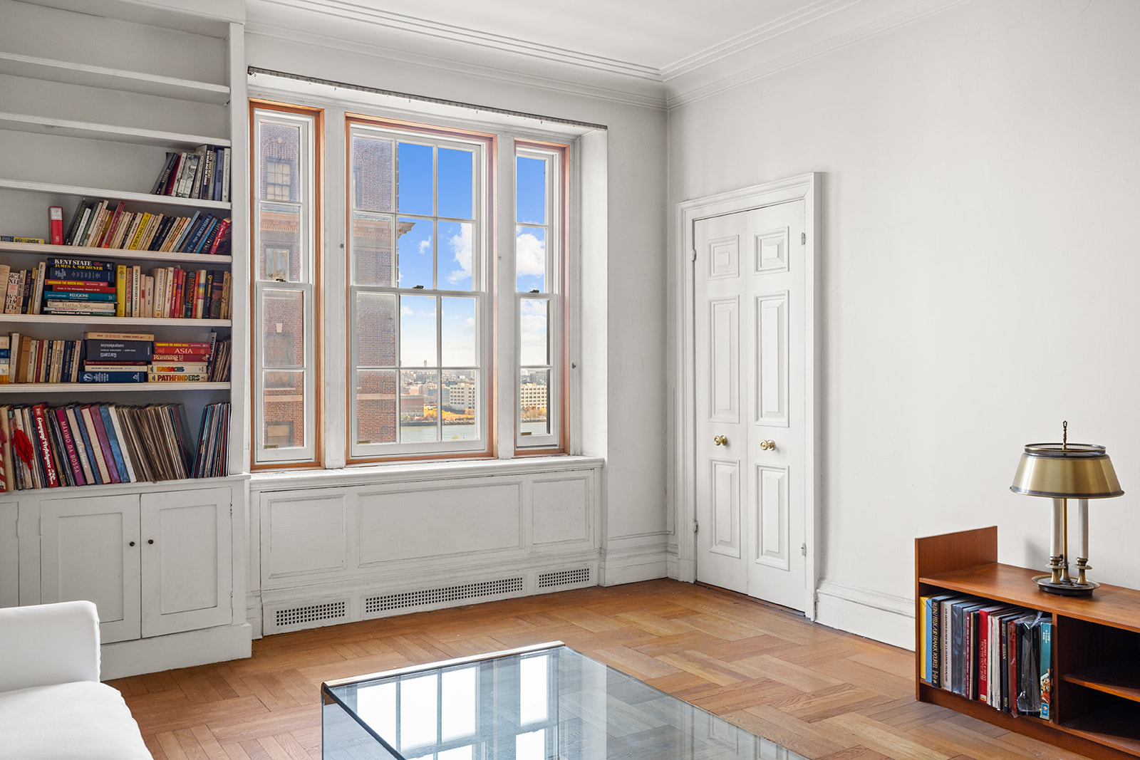 30 Sutton Place, Unit 12E Manhattan, NY 10022 - Photo 2 of 8 a view of an empty room with shelves