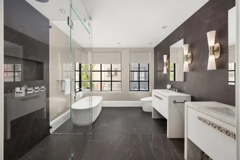 a bathroom with a bathtub and a shower