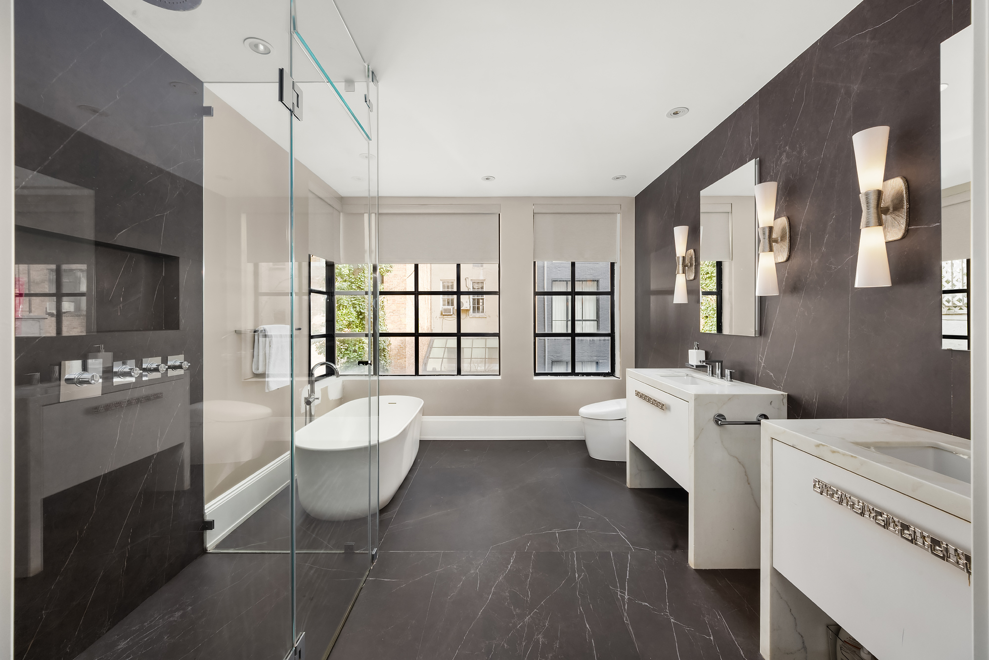 123 East 61st Street Manhattan, NY 10065 - Photo 14 of 31 a spacious bathroom with a bathtub sink and mirror