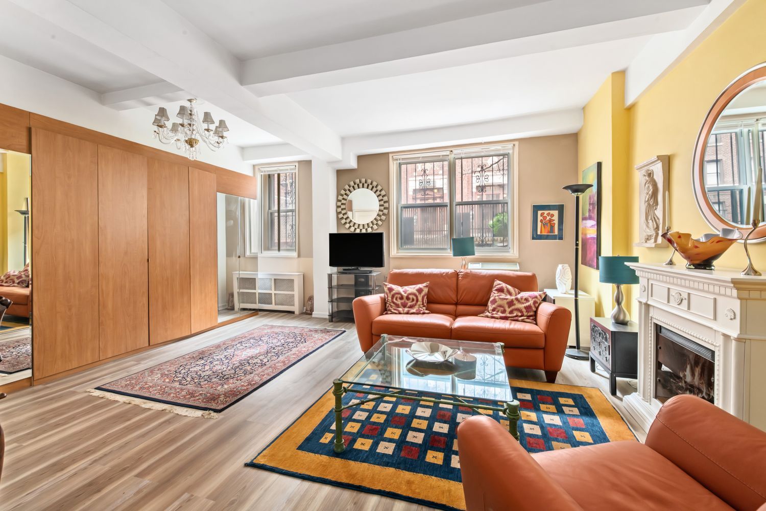 345 East 54th Street Manhattan, NY 10022 - Photo 1 of 10 a living room with fireplace furniture and a flat screen tv