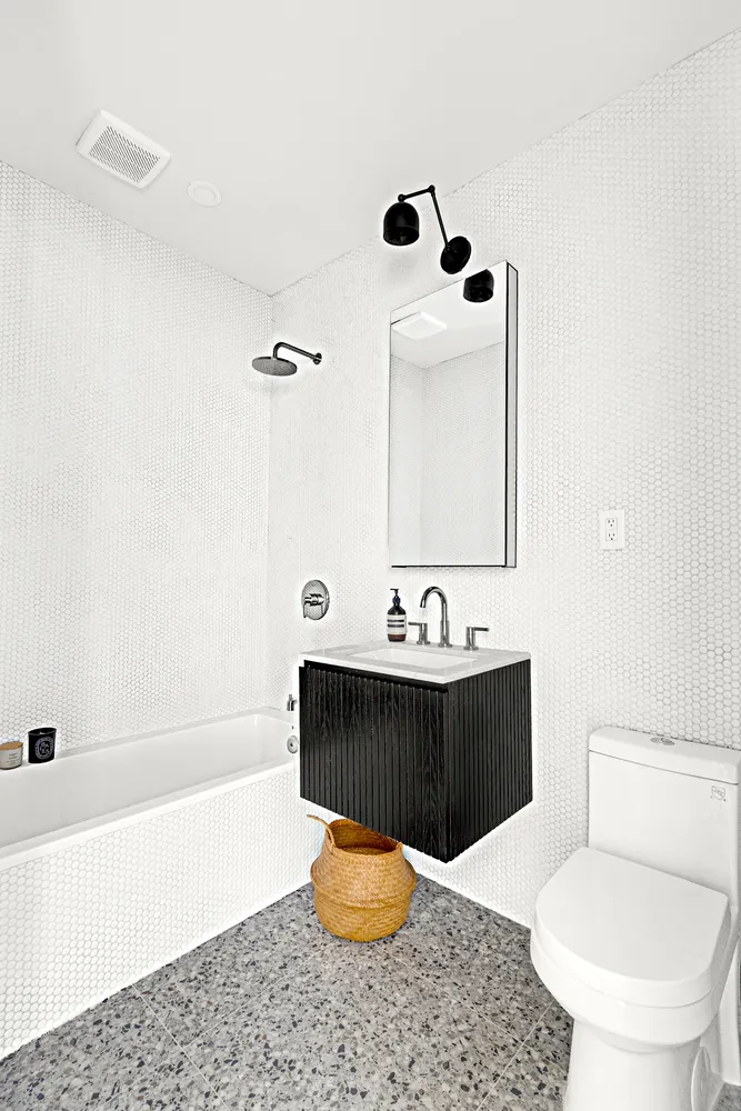 a bathroom with a sink a toilet and bathtub