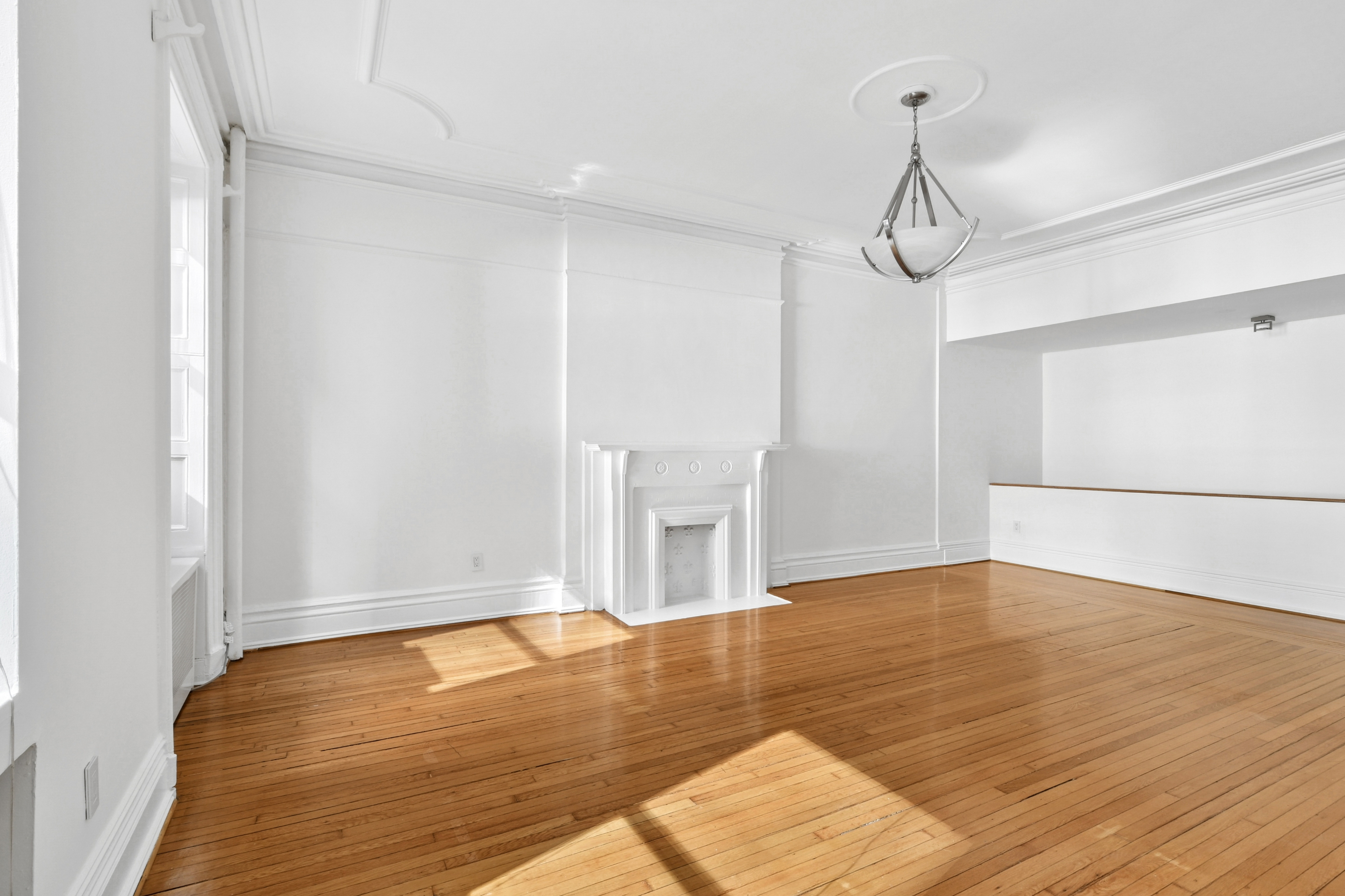 109 East 38th Street, Unit 3A Manhattan, NY 10016 - Photo 9 of 13 a view of an empty room with wooden floor
