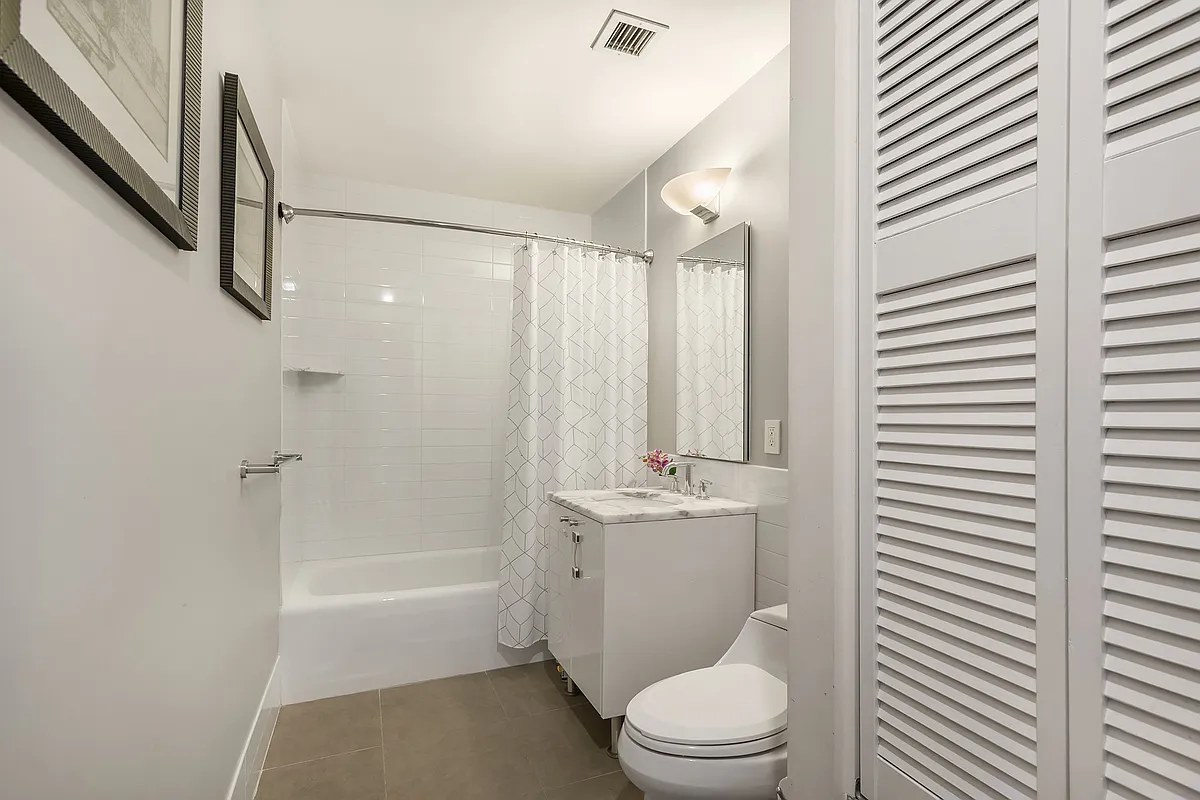 46-30 Center Boulevard, Unit 710 Queens, NY 11109 - Photo 11 of 25 a bathroom with a toilet a sink and bathtub