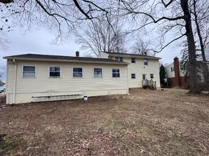 a view of a house with a backyard