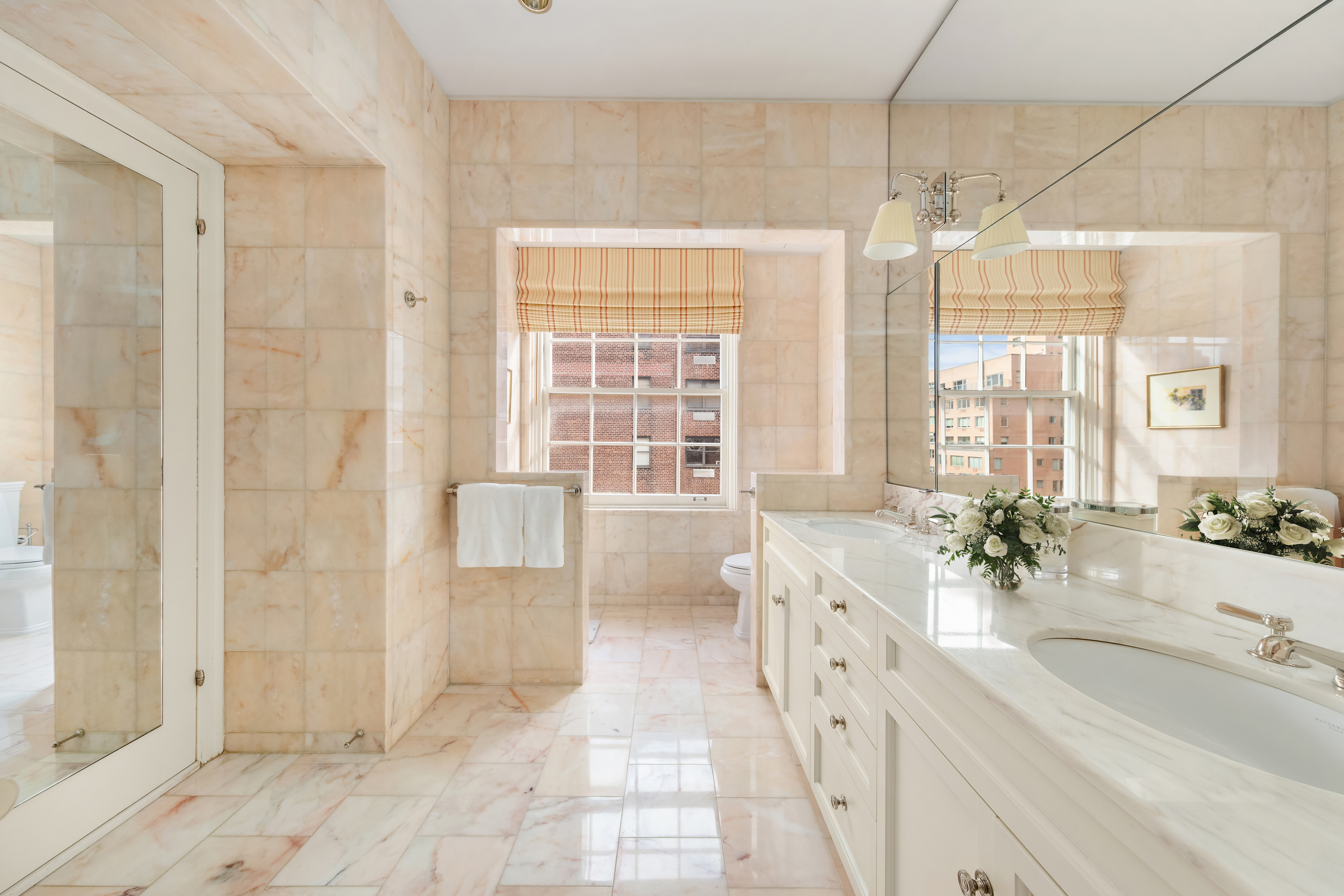 14 Sutton Place South, Unit PHA Manhattan, NY 10022 - Photo 10 of 22 a spacious bathroom with a double vanity sink a large mirror and a bathtub