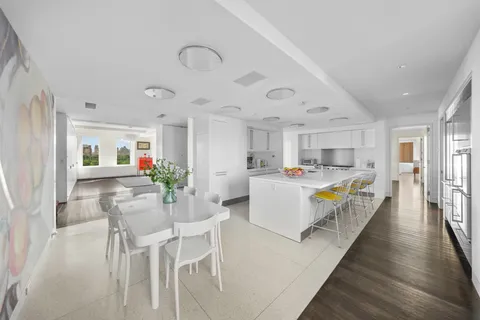 a living room with kitchen island furniture and a wooden floor