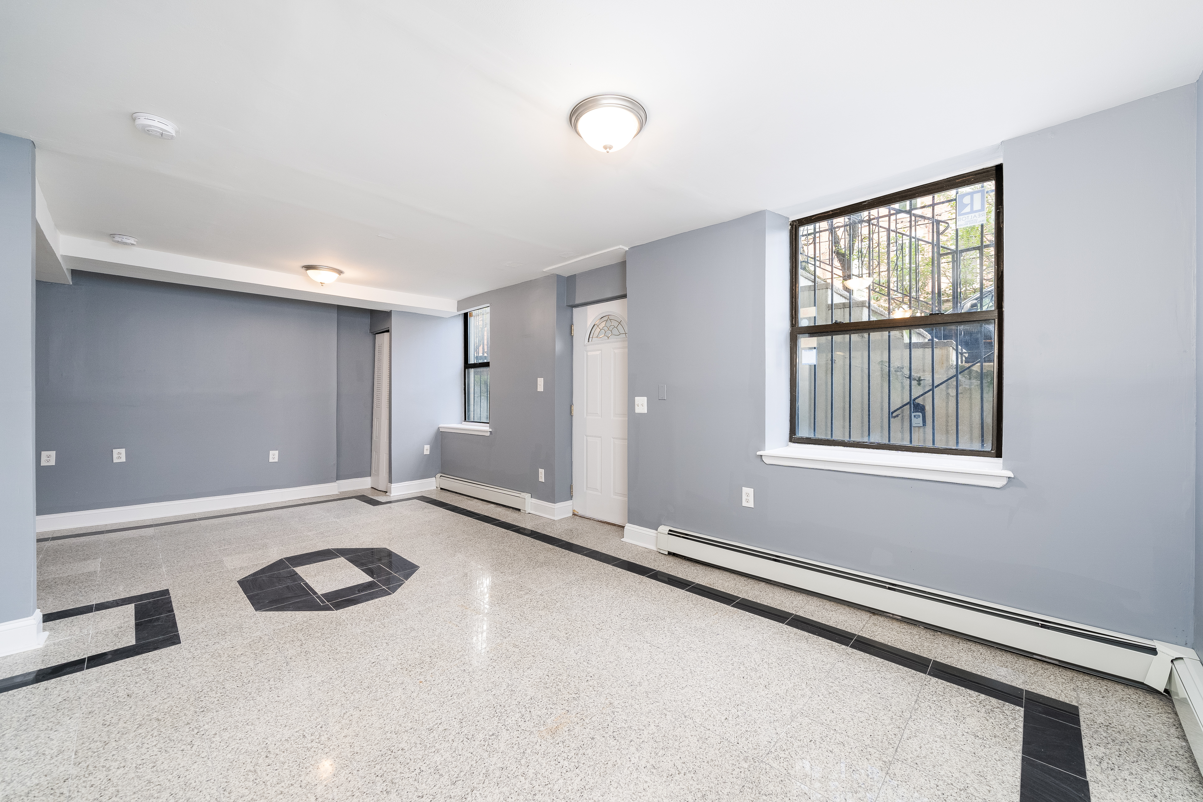 168 Coles Street, Unit BA Jersey City, NJ 07302 - Photo 5 of 29 a view of an empty room with a window