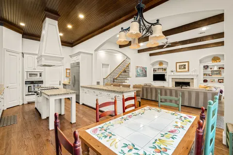 a view of a kitchen with furniture and wooden floor