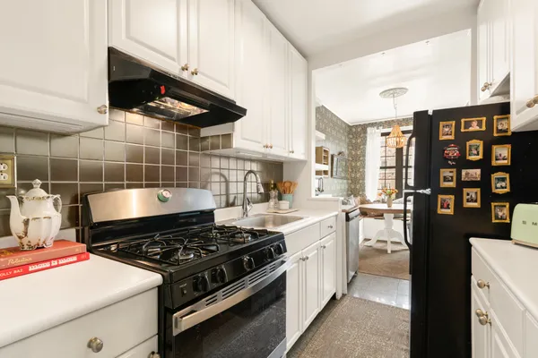 a stove top oven sitting inside of a kitchen