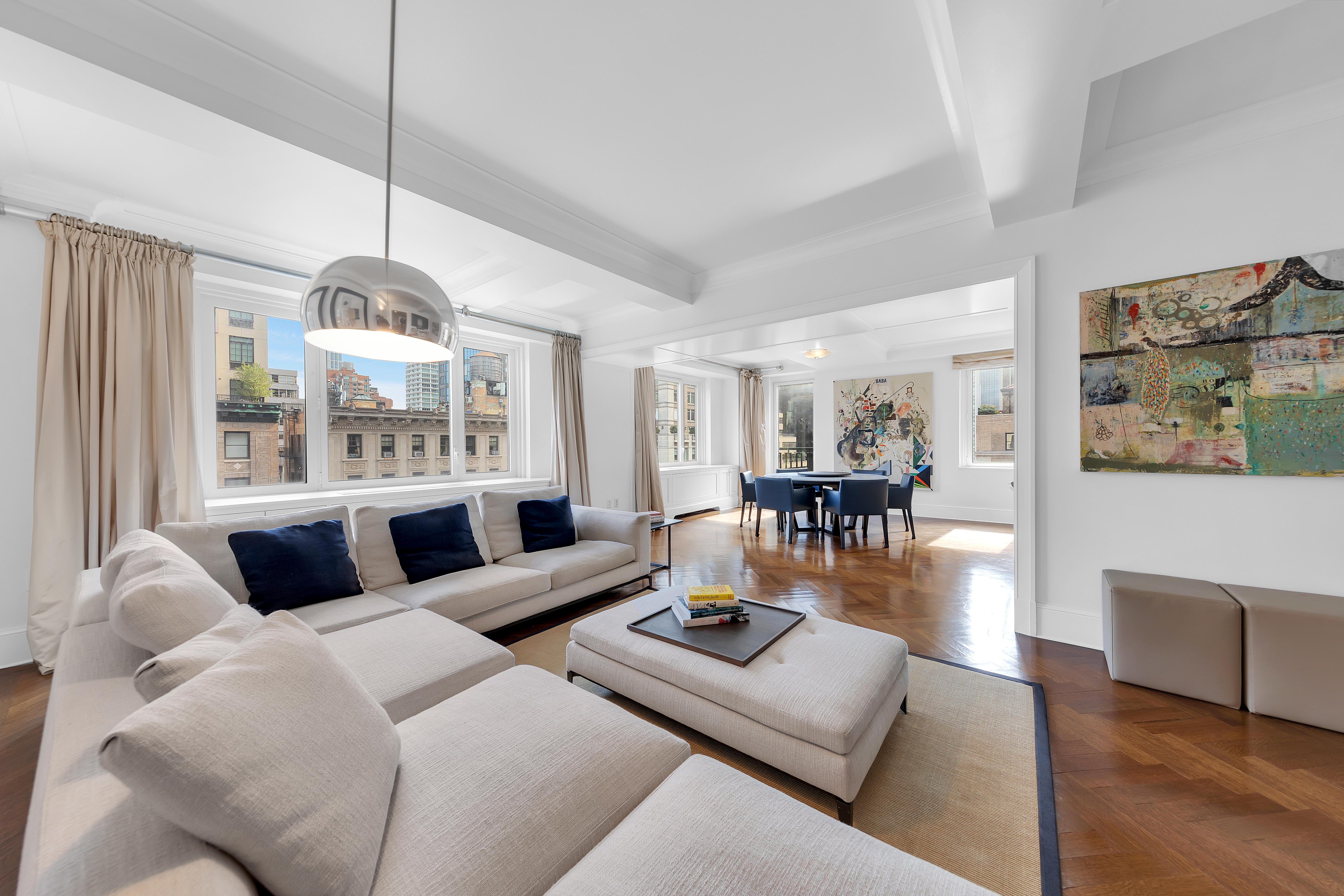 a living room with furniture chandelier and a large window