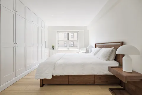 a bedroom with a bed and a night stand