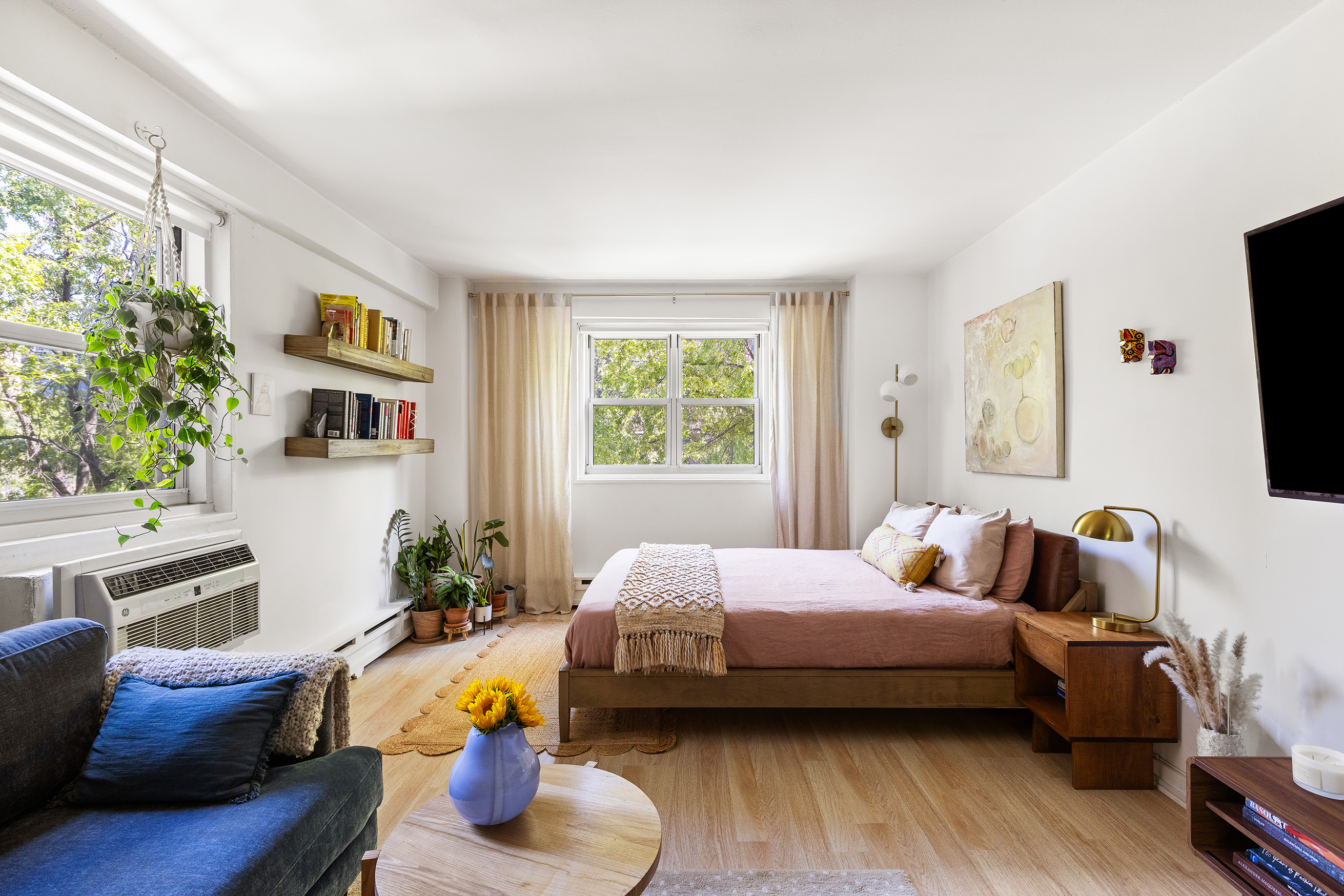 a bedroom with furniture and a flat screen tv