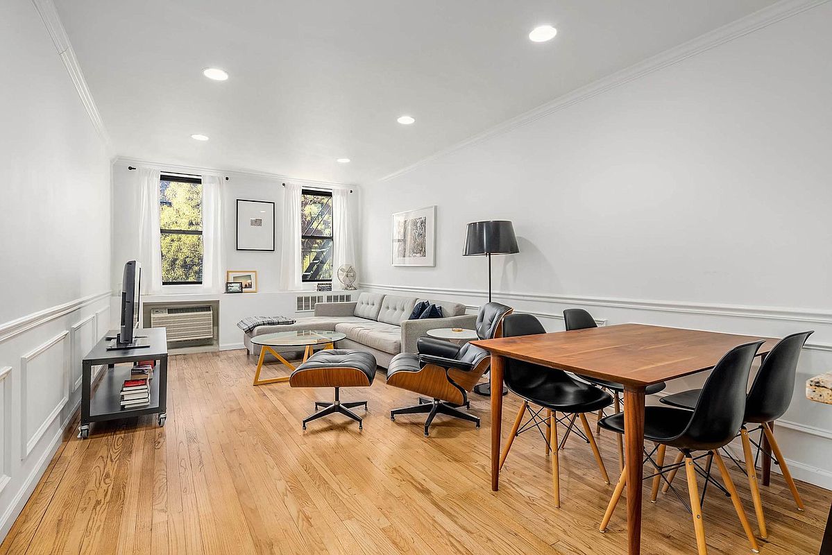215 East 77th Street, Unit 4C Manhattan, NY 10075 - Photo 1 of 7 a living room with furniture and wooden floor
