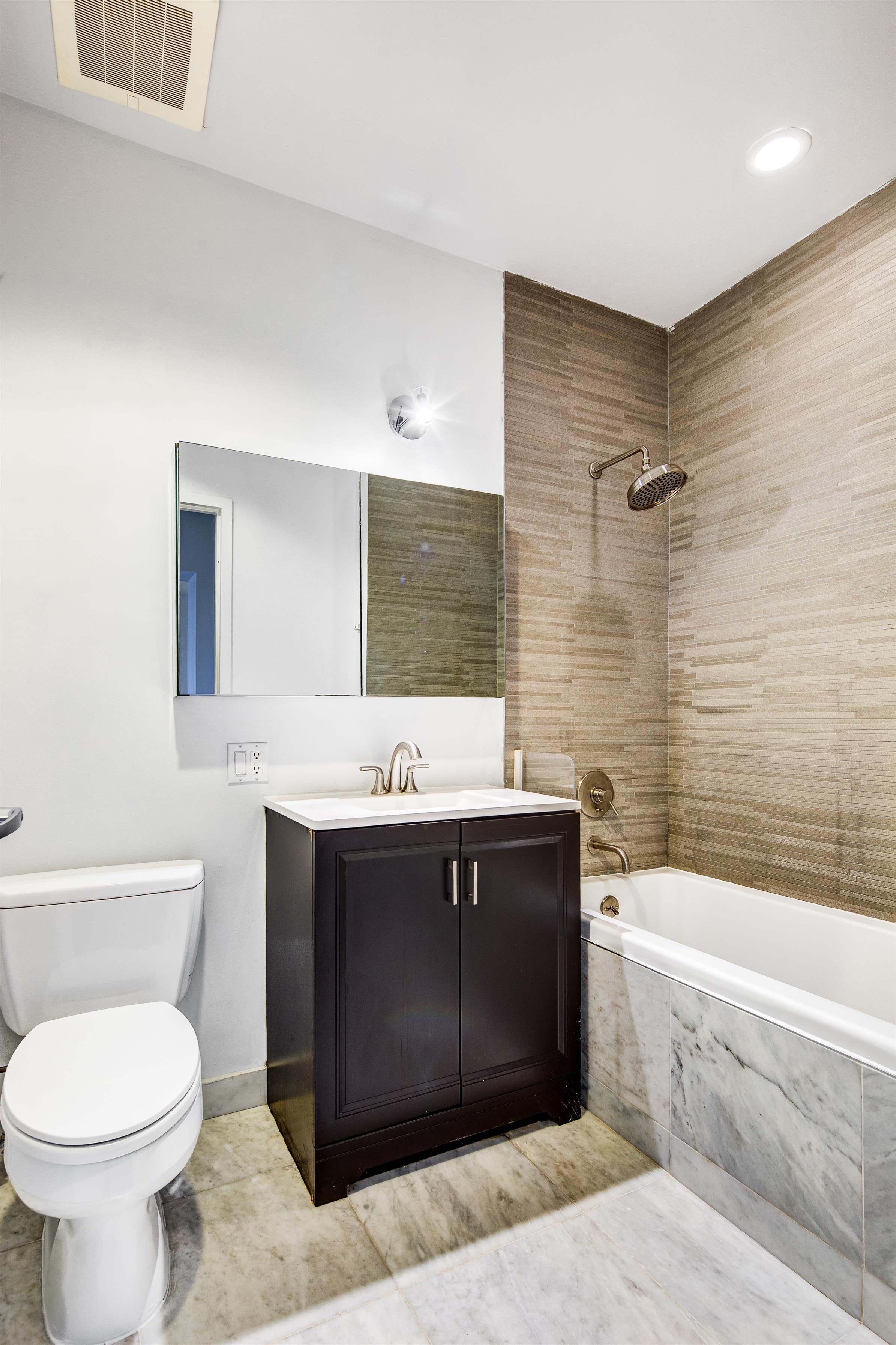 836 Bergen Street, Unit 304 Brooklyn, NY 11238 - Photo 3 of 12 a bathroom with a sink toilet and shower