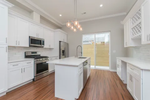 a kitchen with a stove a sink and a refrigerator