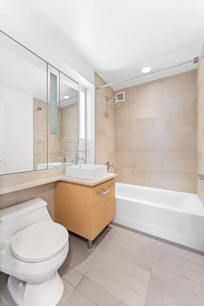 a bathroom with a toilet a sink and bathtub