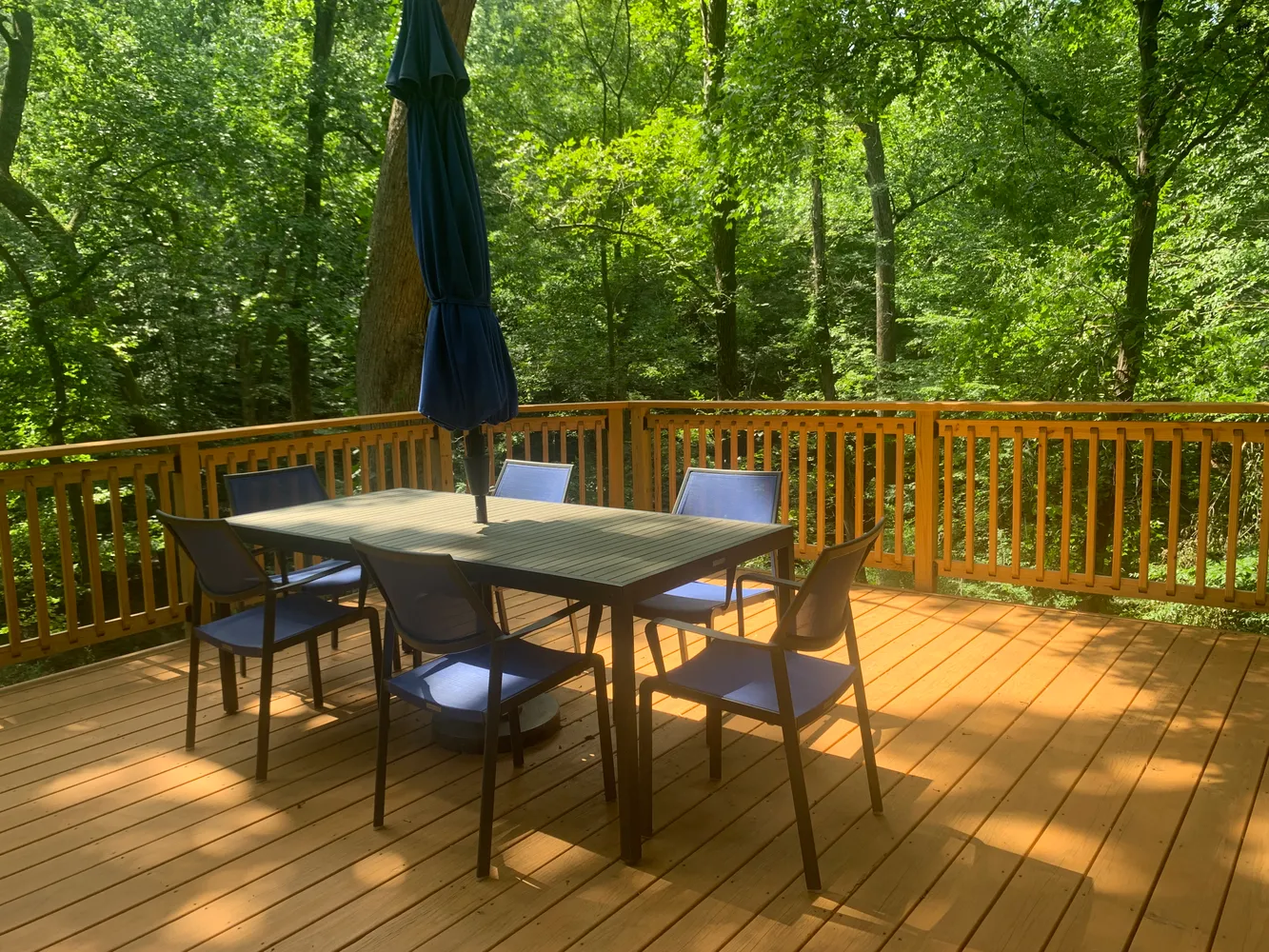 a view of a chairs and table on the deck