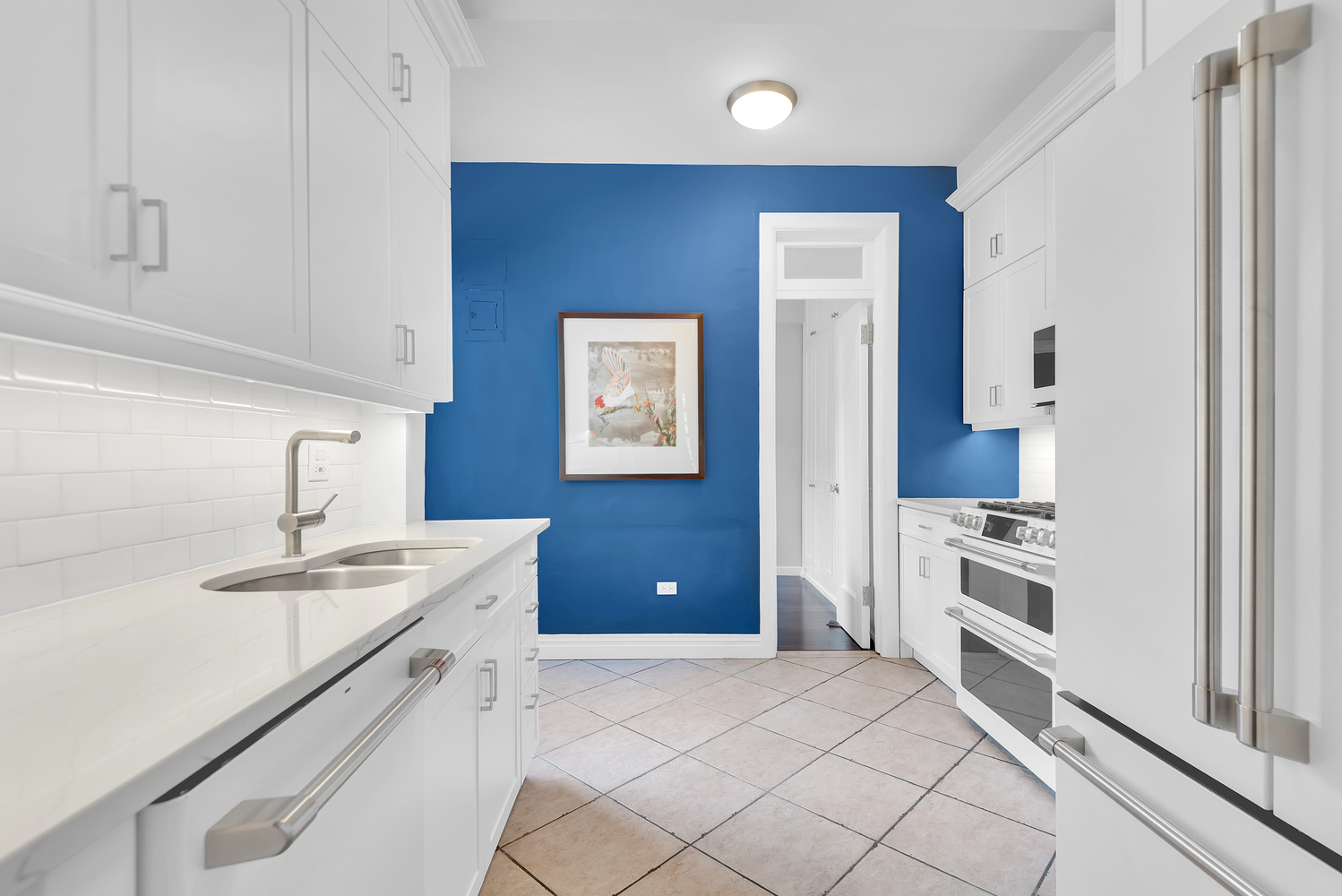 122 East 82nd Street, Unit 8C Manhattan, NY 10028 - Photo 7 of 15 a kitchen with a sink stove and refrigerator