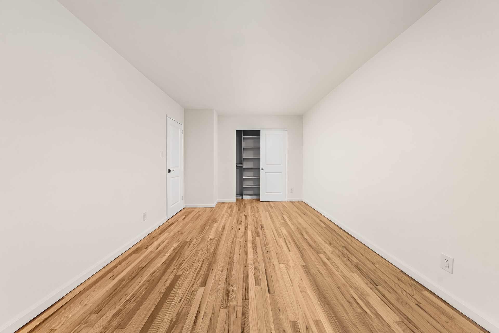 412 Fairview Avenue, Unit 1 Queens, NY 11385 - Photo 7 of 9 a view of empty room with wooden floor