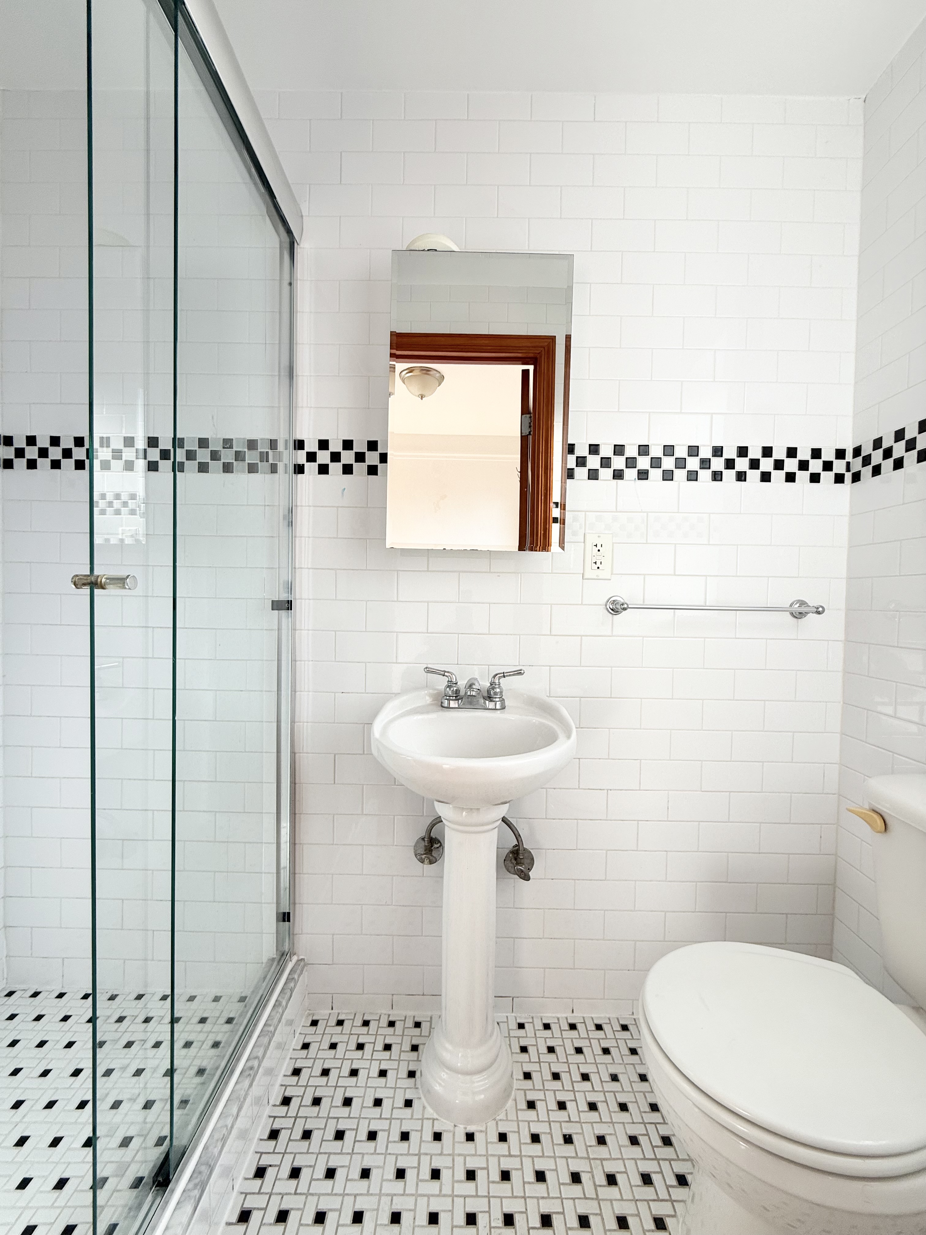 675 West End Avenue, Unit 12A Manhattan, NY 10025 - Photo 11 of 15 a bathroom with a sink a toilet a window and shower