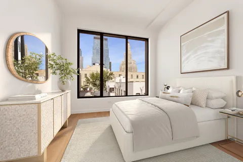 a spacious bedroom with a large bed and a window